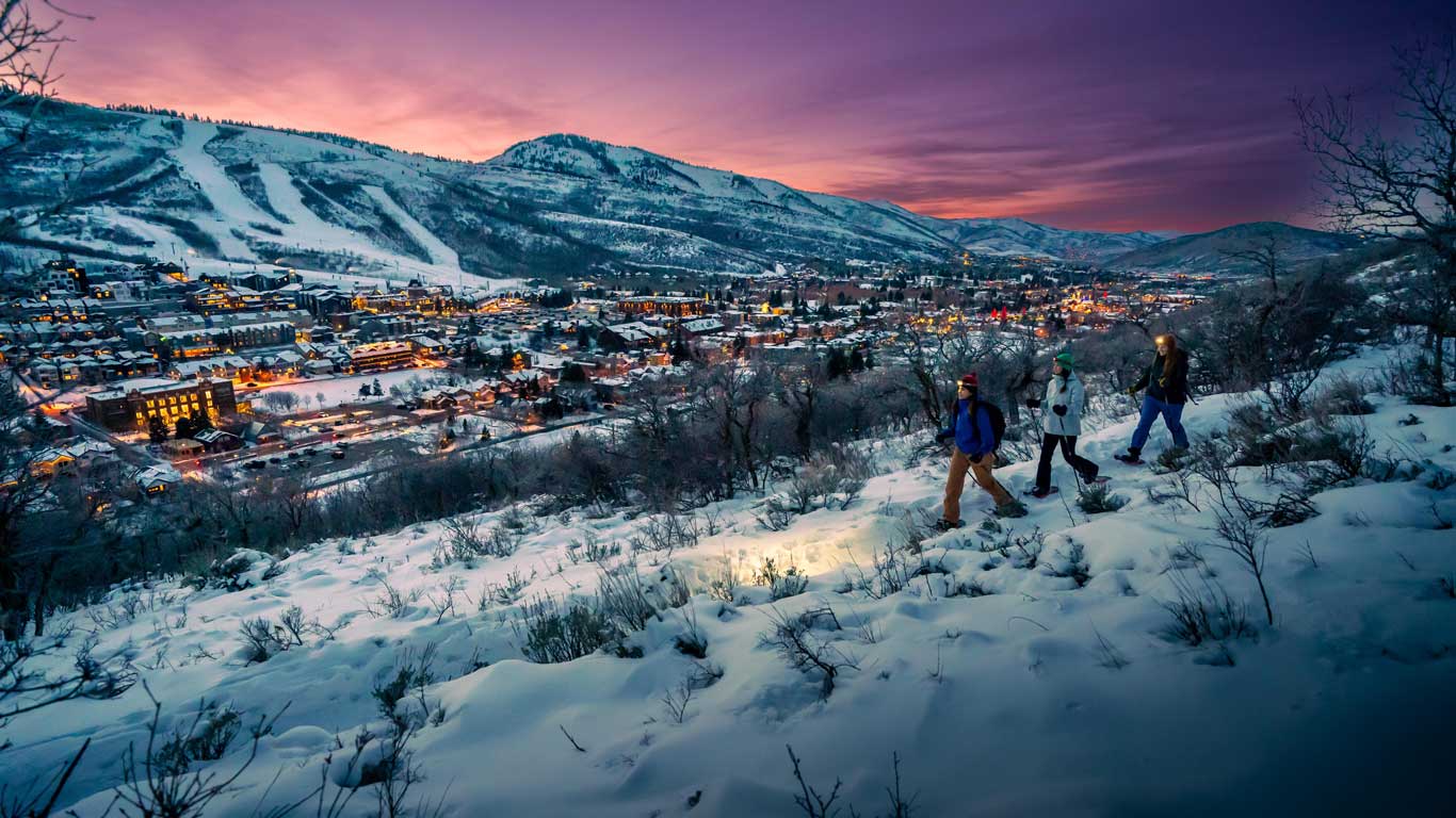 White Pine Touring guide leads a Moonlight Snowshoe Tour in Park City, UT