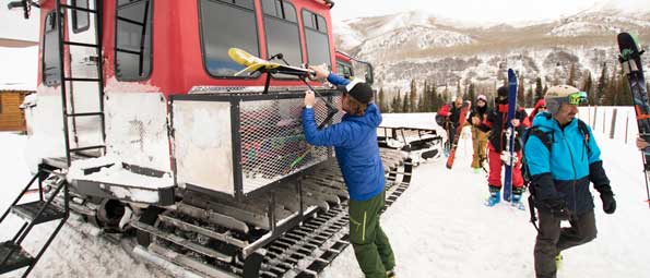 Skiers in front of a snow cat in the Uinta Mountains