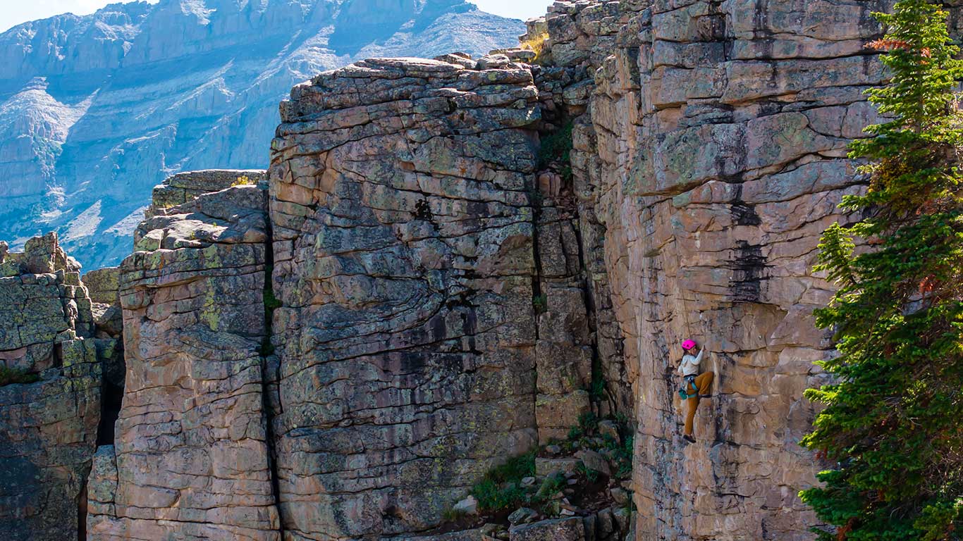 White Pine Touring guide leading a rock climbing route on a guided climbing trip in the Uinta mountains near Park City, UT