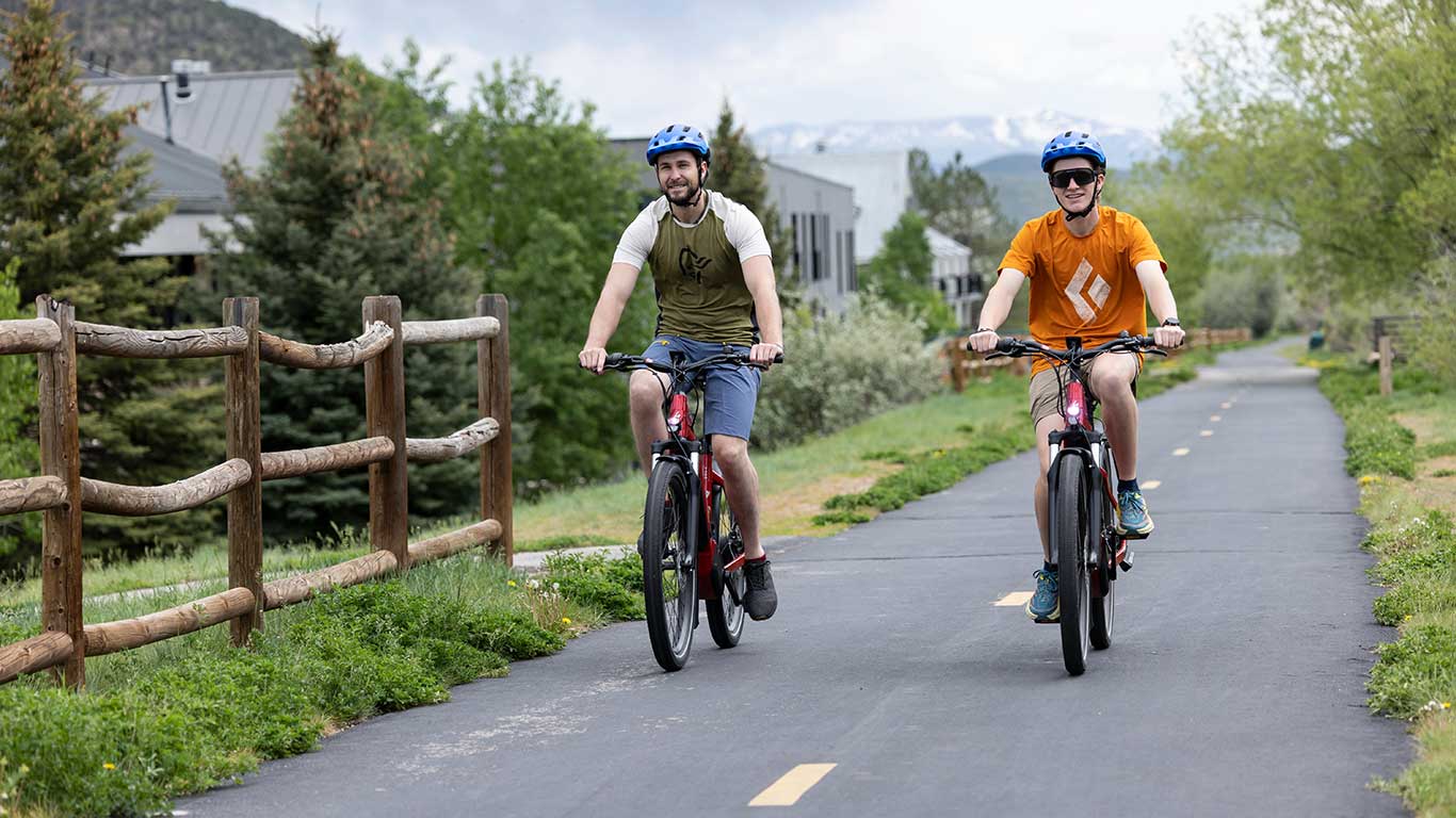 White Pine Guides riding E-bikes on a trail in Park City, UT.