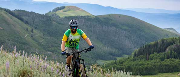 White Pine Touring mountian biker riding on a trail in Park City, UT