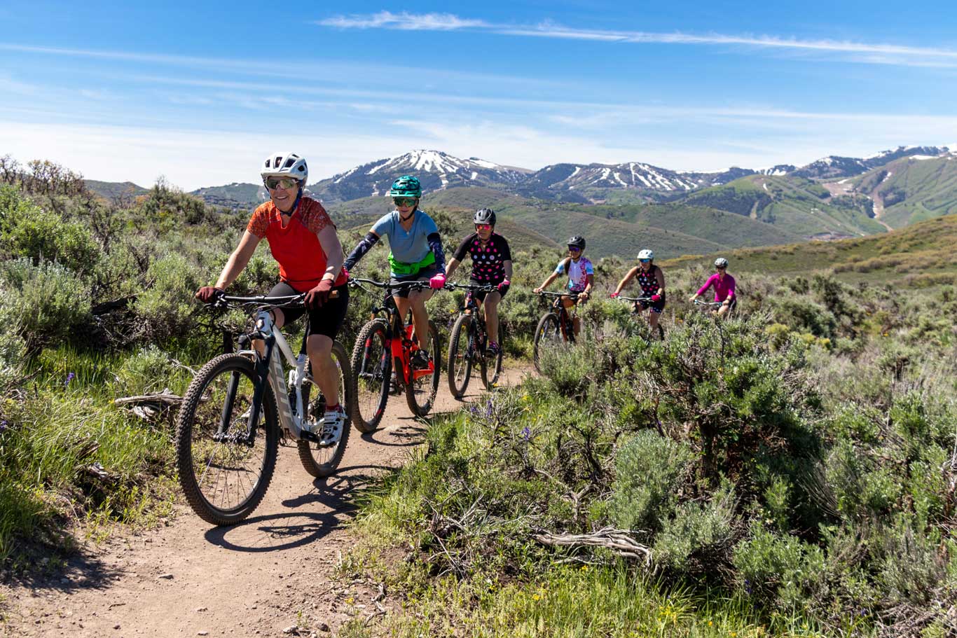 A group of women riding mountain bikes in Round Valley, Park City, UT.